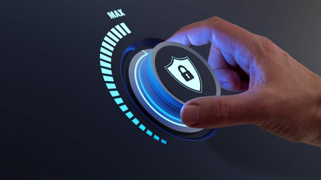 Image is of a security lock button being activated by a persons hand.