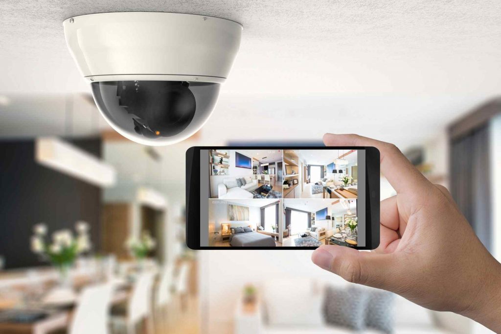 Hand holding 3d rendering mobile connect with security camera.