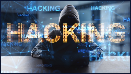 "Hacking" in bold letters with a dark hooded thief in the background.